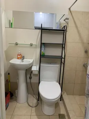 a bathroom with a toilet and a sink at M&L Condotel in Santo Domingo