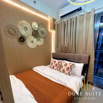 a small bedroom with a bed with white sheets and pillows at Aesthetic walking distance to MOA,near NAIA AIRPORT with NETFLIX,MINIVIDEOKE,BOARDGAMES-DUXE9 in Manila