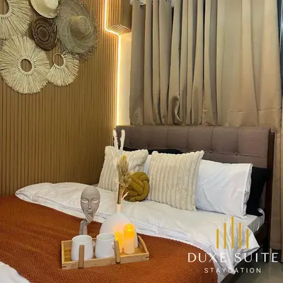 a bed with a table with a tray of food on it at Aesthetic walking distance to MOA,near NAIA AIRPORT with NETFLIX,MINIVIDEOKE,BOARDGAMES-DUXE9 in Manila