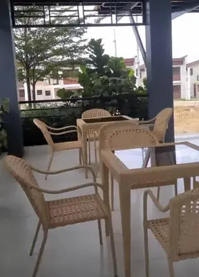 a group of chairs and tables on a patio at Transient Room in Dasmariñas