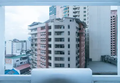 a view of a tall white building from a window at RedDoorz at MPT Suites Test in Manila