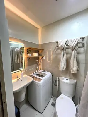 a bathroom with a white toilet and a sink at Aesthetic walking distance to MOA,near NAIA AIRPORT with NETFLIX,MINIVIDEOKE,BOARDGAMES-DUXE5 in Manila