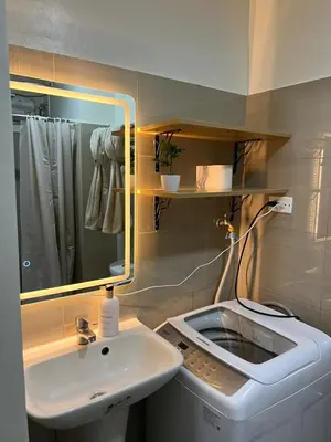 a bathroom with a white sink and a mirror at Aesthetic walking distance to MOA,near NAIA AIRPORT with NETFLIX,MINIVIDEOKE,BOARDGAMES-DUXE5 in Manila