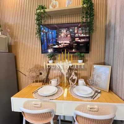 a dining room table with chairs and plates on it at Aesthetic walking distance to MOA,near NAIA AIRPORT with NETFLIX,MINIVIDEOKE,BOARDGAMES-DUXE5 in Manila