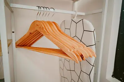 a closet with a hanger with orange clothes at Picturesque 3BR home near Thunderbird, Overlooking in Binangonan
