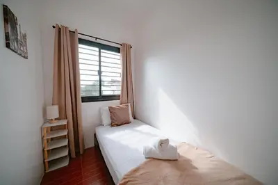 a bedroom with a twin bed and a window at Picturesque 3BR home near Thunderbird, Overlooking in Binangonan
