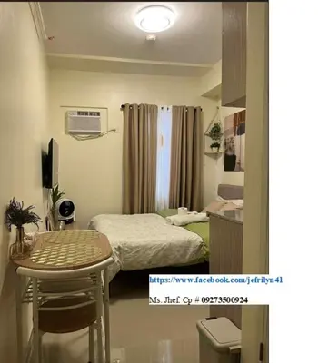 a small room with a bed and a table at Aesthetic Studio Unit at Deca Cubao QC in Manila