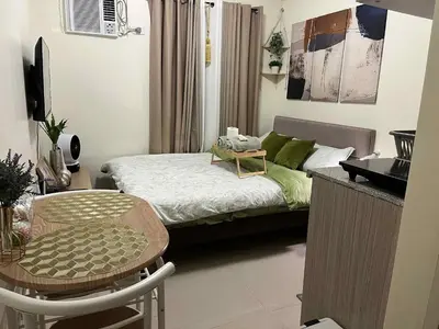 a small room with a bed and a table and a chair at Aesthetic Studio Unit at Deca Cubao QC in Manila