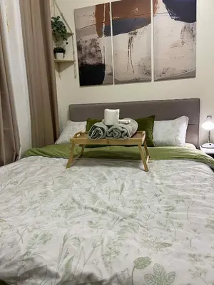 a bed with a table on top of it at Aesthetic Studio Unit at Deca Cubao QC in Manila