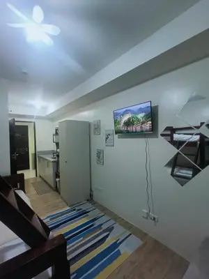 a room with a white wall with a tv on the wall at DongStay in Bayabasan