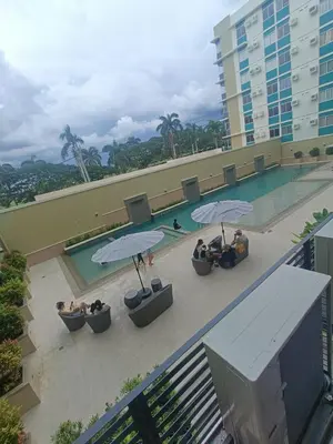 an overhead view of a swimming pool with umbrellas at DongStay in Bayabasan