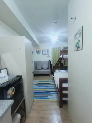 a small room with a bed and a couch at DongStay in Bayabasan