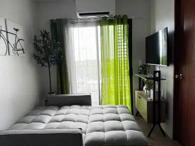 a living room with a large bed in front of a window at Casa Dreamer in Taytay