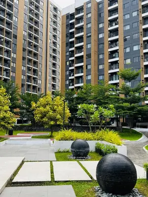 two black spheres in a park with tall buildings at Casa Dreamer in Taytay