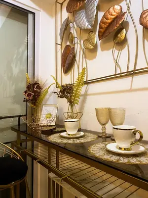 a table with two cups and plates on it at Hiraya Vacation at Azure Urban Resorts in Manila