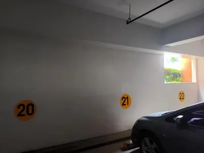 a car parked in a garage with numbers on the wall at Nature Green Room Paseo Verde at Calle Real in Manila