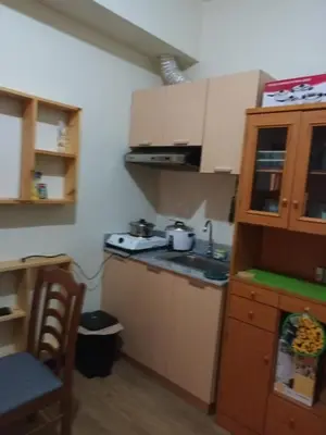 a small kitchen with a sink and a stove at Nature Green Room Paseo Verde at Calle Real in Manila