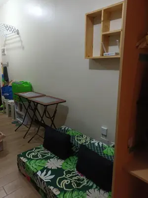 a living room with a couch and a table at Nature Green Room Paseo Verde at Calle Real in Manila