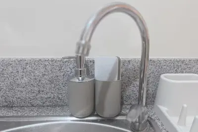 two complimentary toothbrushes sitting on a kitchen sink at Cozy Elegance Staycation in Silang