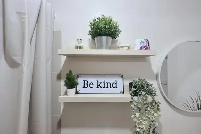 a shelf with a sign that says be kind at Cozy Elegance Staycation in Silang