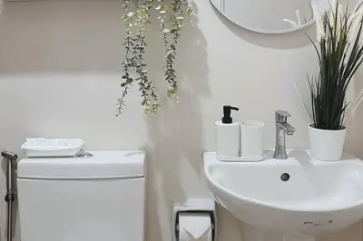 a white bathroom with a sink and a toilet at Cozy Elegance Staycation in Silang
