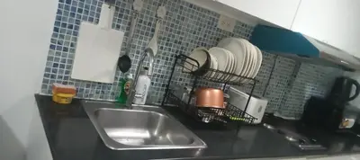 a kitchen counter with a sink and utensils at Tower C sea residence manolita in Manila