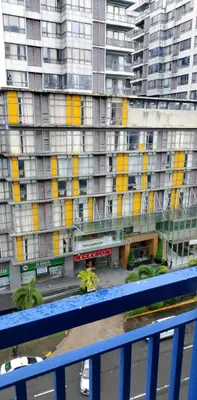 a view of a large building with yellow windows at Tower C sea residence manolita in Manila