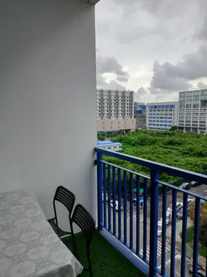 a balcony with a table and chairs and buildings at Tower C sea residence manolita in Manila