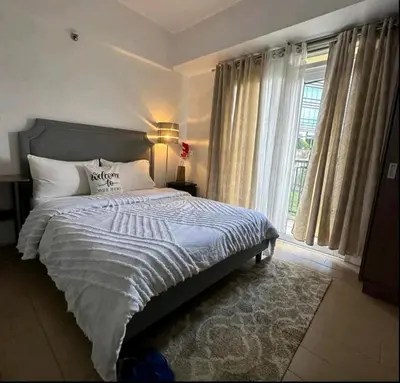a bedroom with a large bed and a window at 150 Newport Boulevard - North Wing in Manila