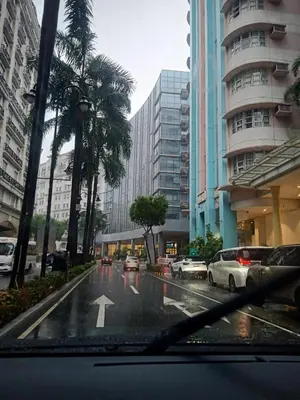 a view of a city street with cars in the rain at 150 Newport Boulevard - North Wing in Manila