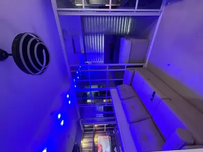 an empty room with a couch and blue lights at Shore 2 tower 1 staycation in Manila