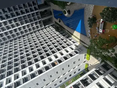 an overhead view of a large white building with a pool at Shore 2 tower 1 staycation in Manila