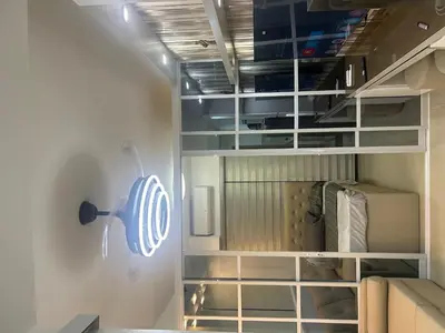 a closet with white shelves and a refrigerator at Shore 2 tower 1 staycation in Manila