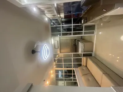 a room with a staircase with a light on the wall at Shore 2 tower 1 staycation in Manila