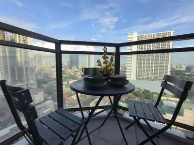 a table and two chairs on a balcony at Condo Unit Near Manila Bay, US Embassy & Iconic Tourist Spots in Manila