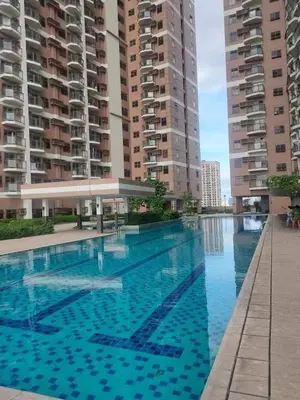 a swimming pool in front of some tall buildings at Condo Unit Near Manila Bay, US Embassy & Iconic Tourist Spots in Manila
