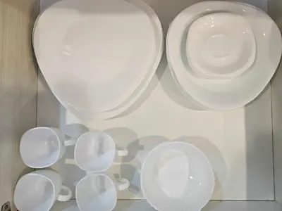 a group of white cups and plates on a shelf at Ashley's Chamber at Soho Central across Shangrila Mall in Manila