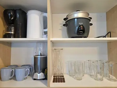 a cupboard filled with lots of glasses and appliances at Ashley's Chamber at Soho Central across Shangrila Mall in Manila