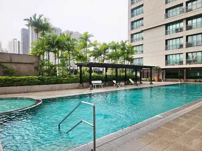 a large swimming pool in front of a building at Ashley's Chamber at Soho Central across Shangrila Mall in Manila