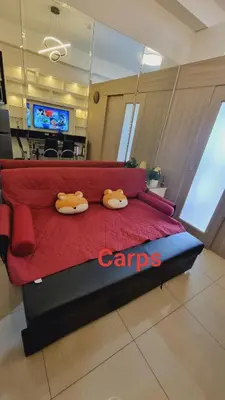 a red bed in a room with two ducks on it at Carps Staycation in Manila