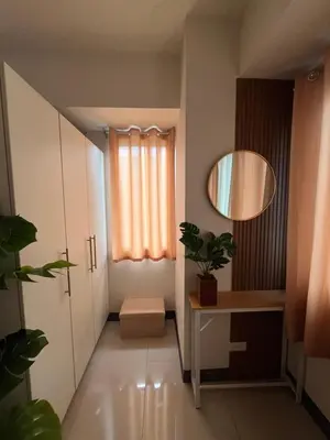 a small hallway with a mirror and a window at Sea Residences Spacious Unit by Ellenn in Manila