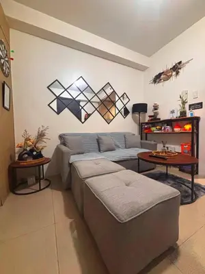 a living room with a couch and a table at SLY Staycation at Shore U-8 in Manila