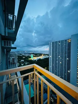 a balcony of a building with a view of the city at Zeke's Staycation in Manila