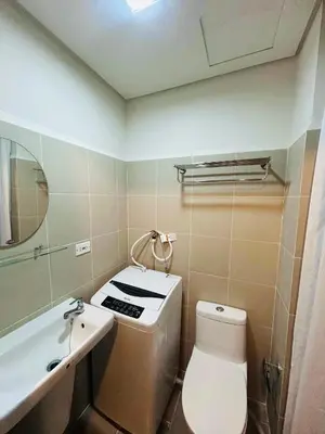 a small bathroom with a toilet and a sink at Zeke's Staycation in Manila