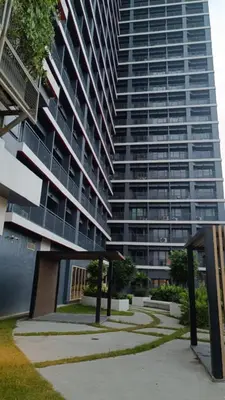 a large apartment building with a large building at Cozy Space at Red Makati City in Manila