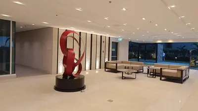 a lobby with a large red sculpture in the middle at Cozy Space at Red Makati City in Manila