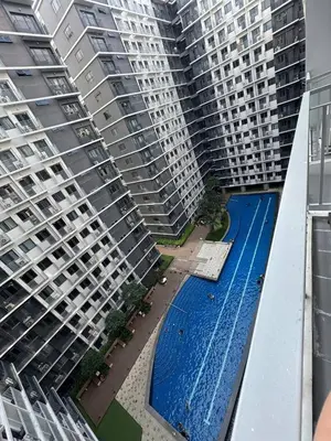 two tall buildings with a swimming pool between them at Unistay Shore 3 Tower 2 10th floor near MOA and AIRPORT in Manila