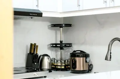 a kitchen counter with a coffee maker on a stove at Urban Stay with Netflix KTV Wifi and Gym Park in Manila
