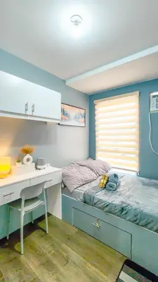 a bedroom with a desk and a bed and a desk and acounter at Urban Stay with Netflix KTV Wifi and Gym Park in Manila