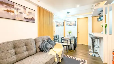 a living room with a couch and a table at Urban Stay with Netflix KTV Wifi and Gym Park in Manila